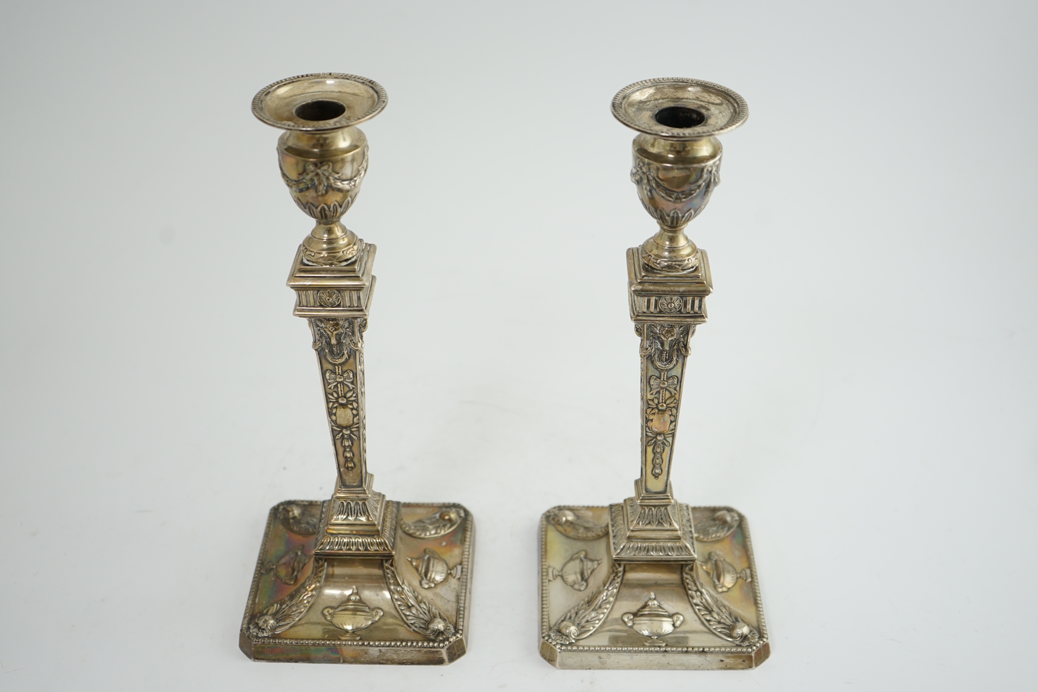 A pair of late Victorian silver Adam style candlesticks, by William Hutton & Sons, (a.f.)